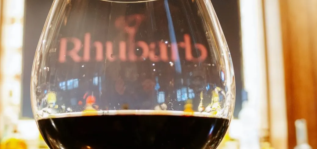 A glass of wine on a bar at night